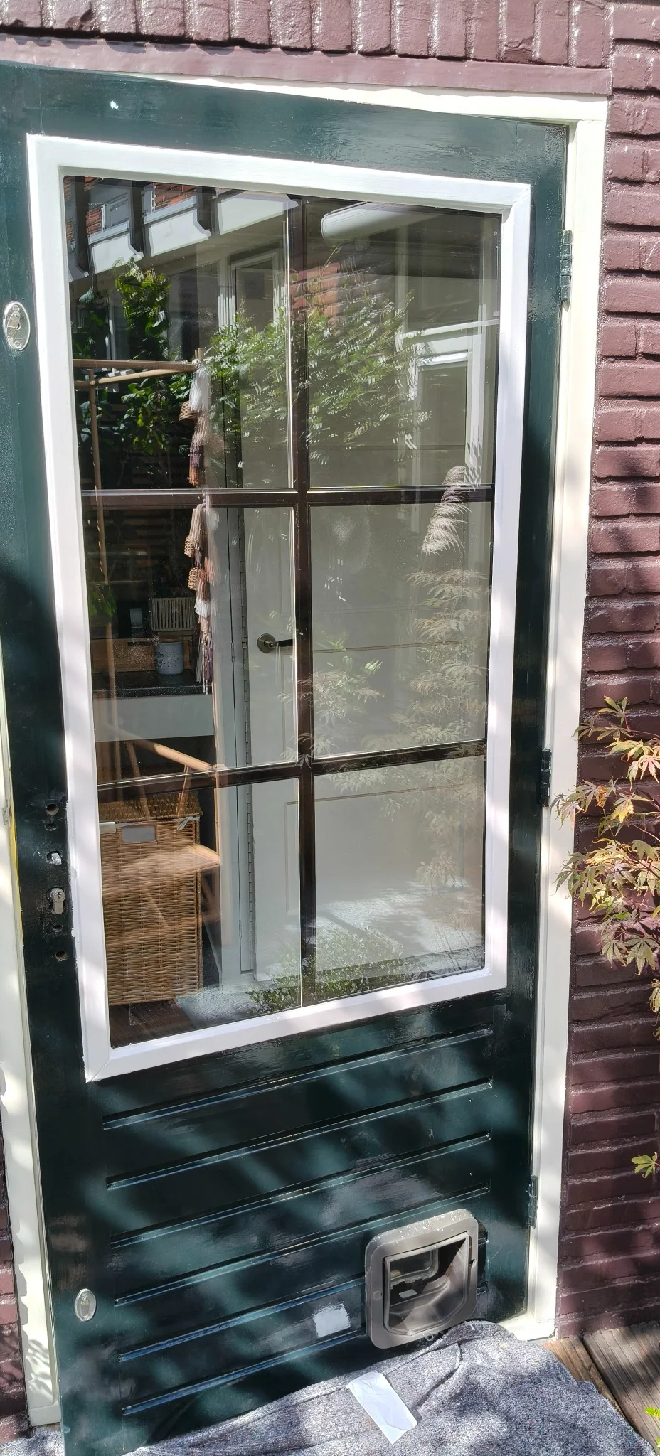 Buitenzijde van een deur met de nieuw geleverde ruit met roedes